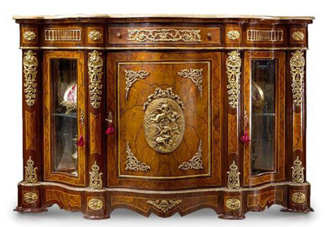 A sophisticated French Napoleon III style ormolu mounted veneer inlaid serpentine shape credenza
